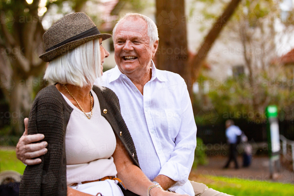 Image of Happy Senior couple sitting on park bench - Austockphoto