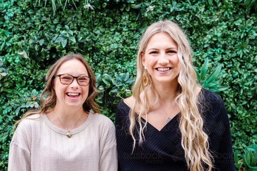 happy sisters, from a series featuring a woman with Down Syndrome - Australian Stock Image