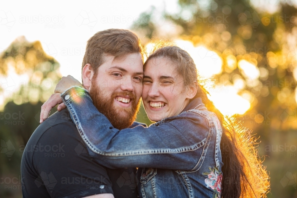 Happy smiling couple close up hugging each other - Australian Stock Image