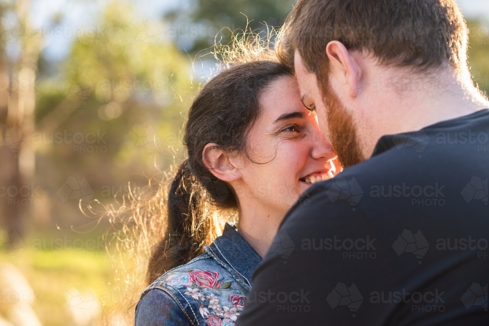 Happy smiling couple with noses touching close together - Australian Stock Image