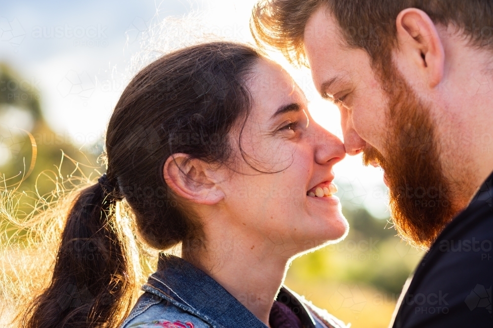 Happy smiling couple with noses touching close together - Australian Stock Image