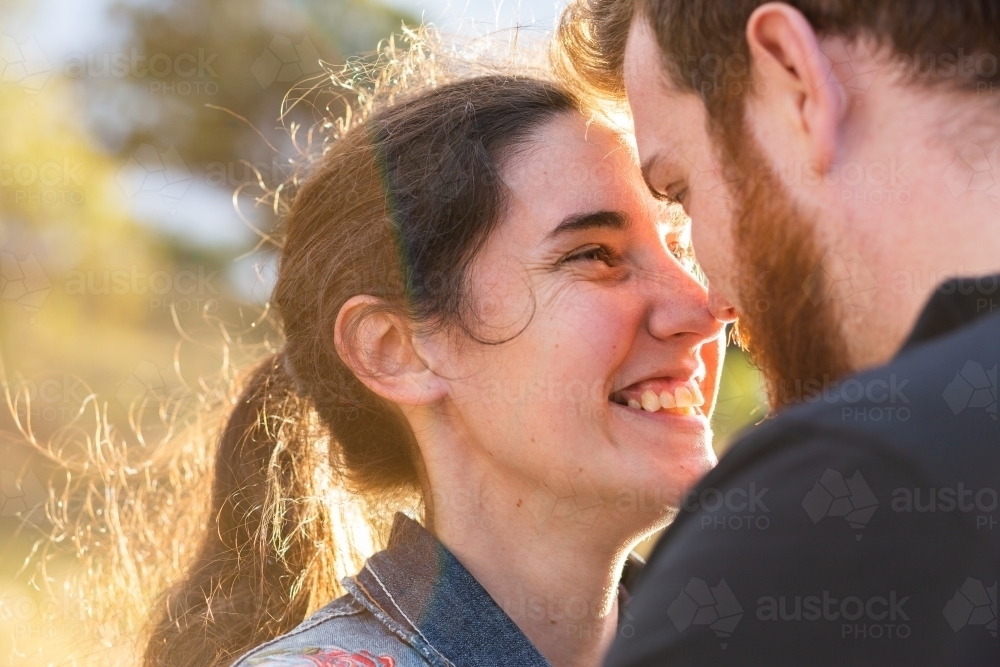Happy smiling couple with noses touching close together - Australian Stock Image