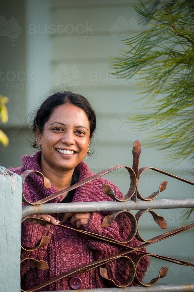Happy smiling lady at the gate - Australian Stock Image