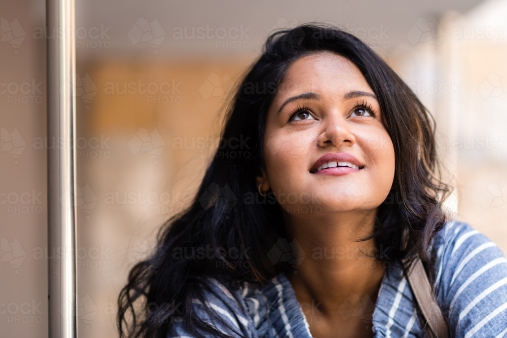 happy smiling woman looking up - Australian Stock Image