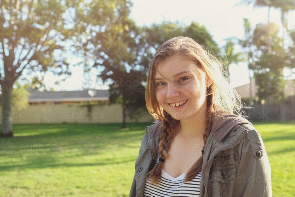 Happy teenage girl in the park - Australian Stock Image