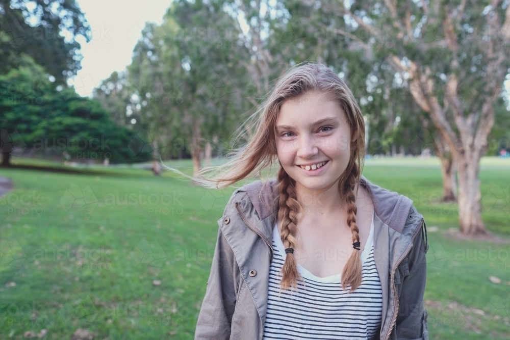 Happy teenage girl in the park - Australian Stock Image