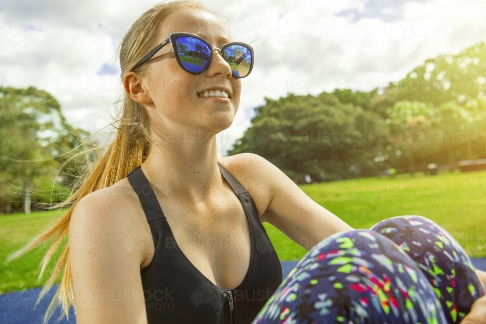 Happy teenage girl training outdoors - Australian Stock Image