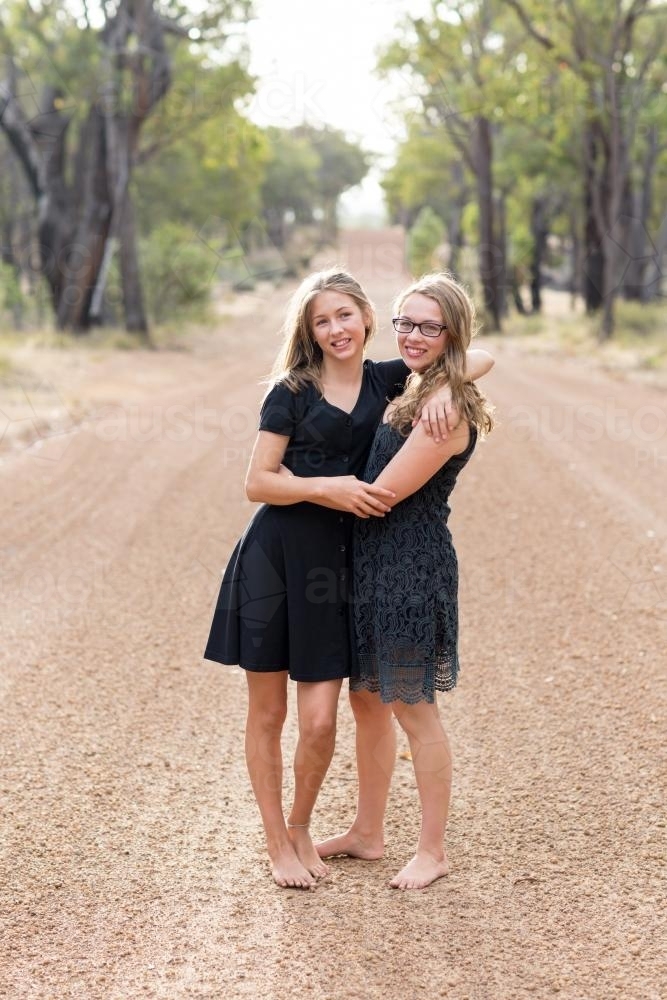 https://www.austockphoto.com.au/imgcache/uploads/photos/compressed/happy-teenage-girls-barefoot-on-country-road-austockphoto-000017707.jpg