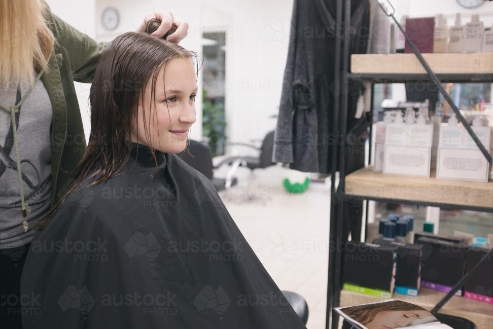 Happy teenager at the hairdresser - Australian Stock Image