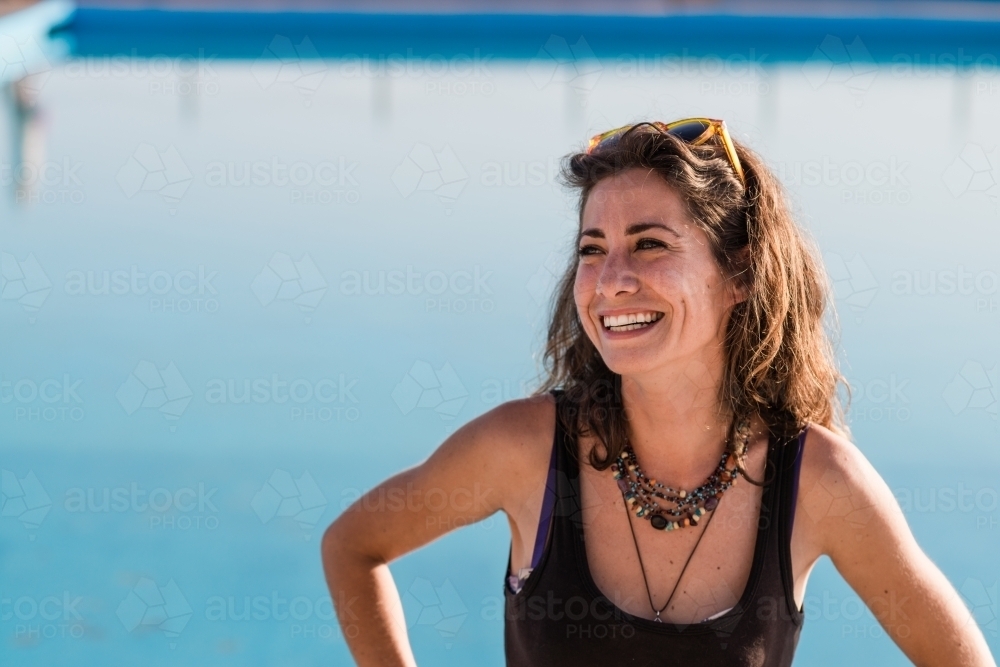 happy woman at ocean swimming pool - Australian Stock Image