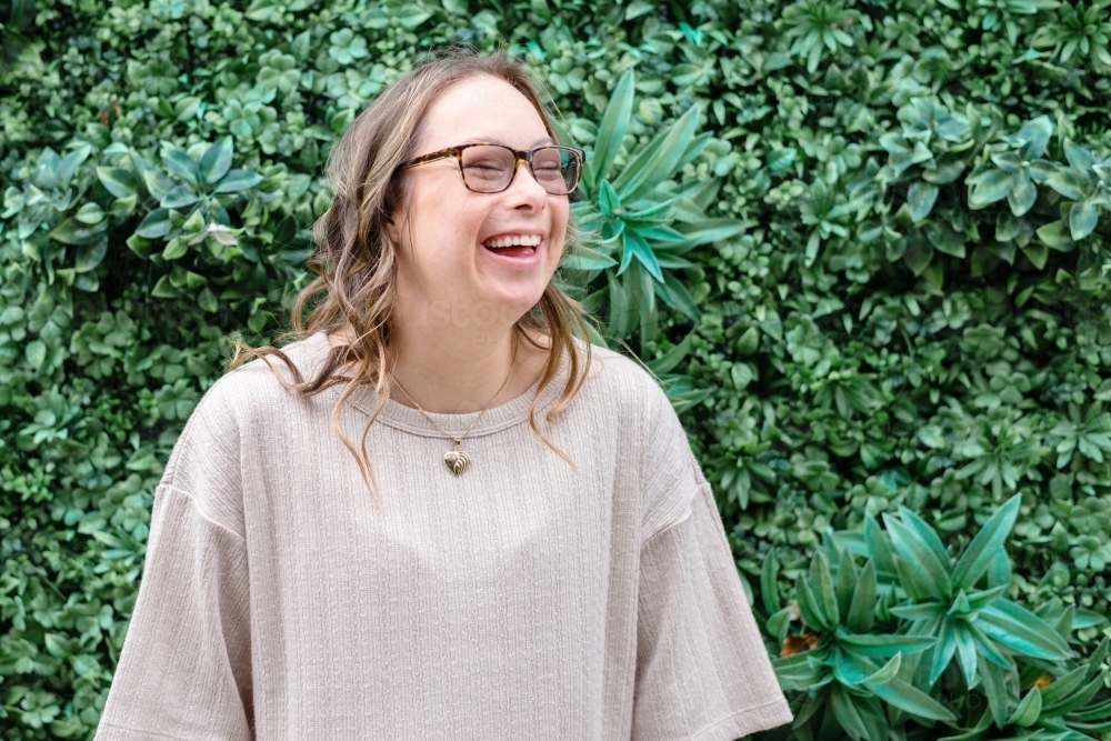 happy woman, from a series featuring a young woman with Down Syndrome - Australian Stock Image