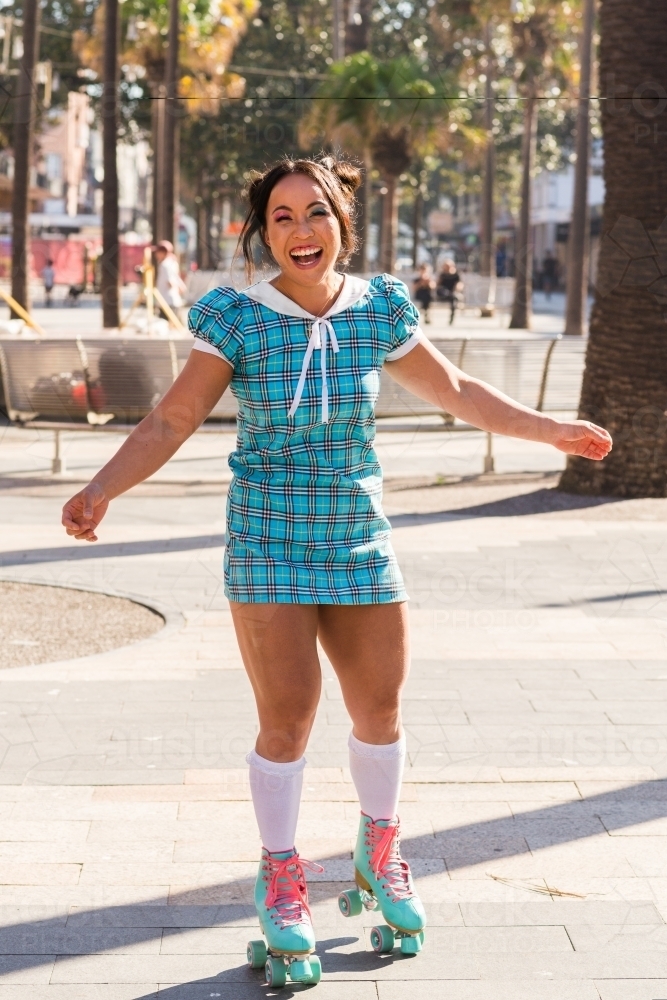 happy woman on roller skates - Australian Stock Image