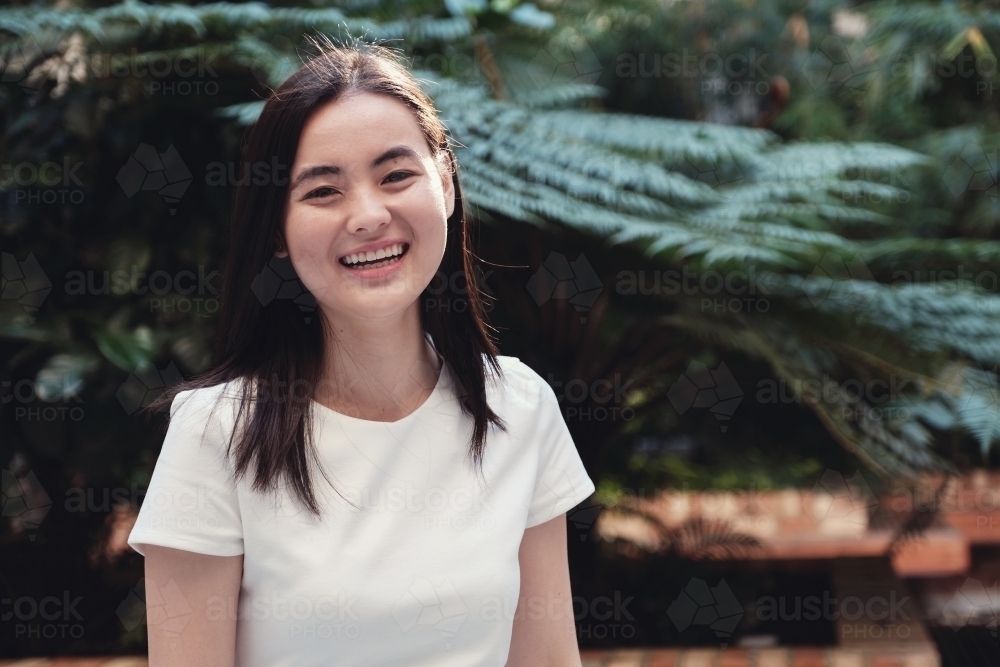 Happy young adult Asian student - Australian Stock Image