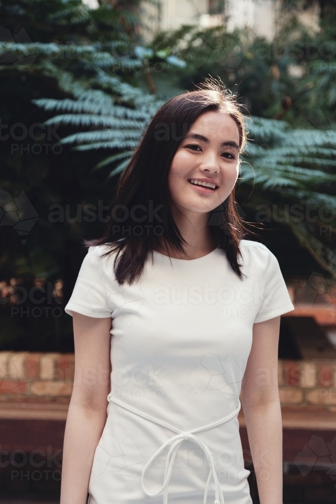 Happy young adult Asian student - Australian Stock Image