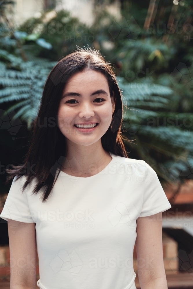 Happy young adult Asian student - Australian Stock Image