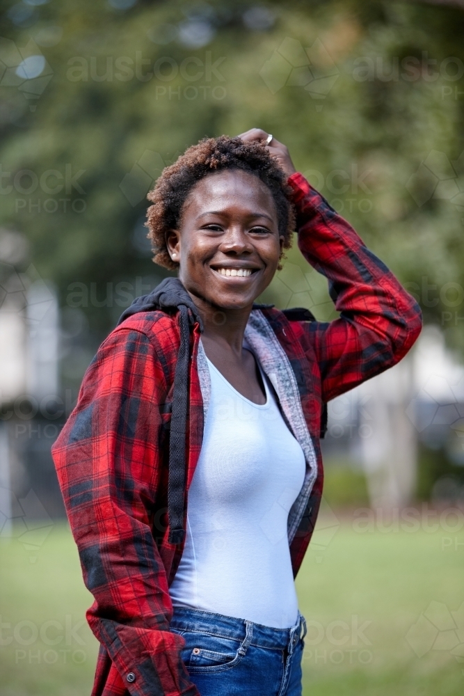 Happy young African woman outdoors - Australian Stock Image