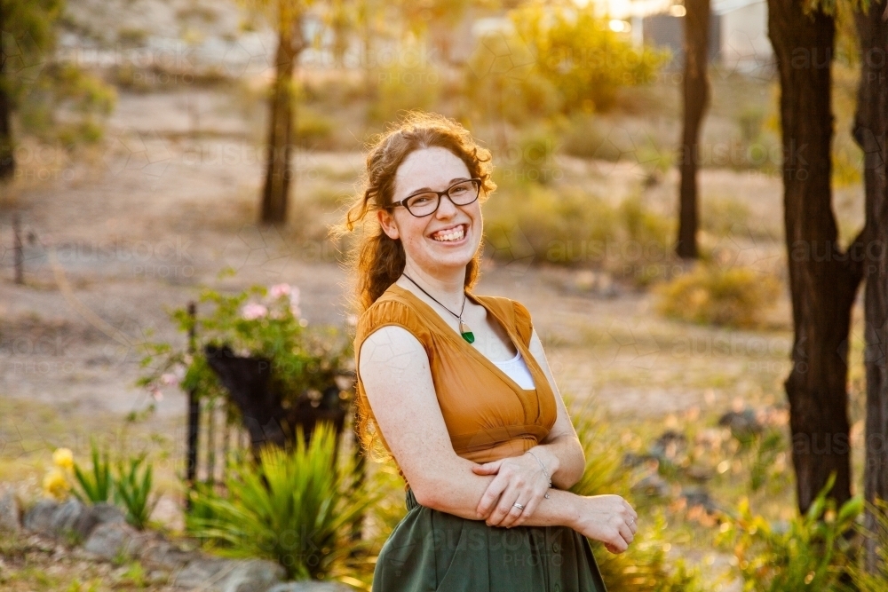 Happy young australian woman in her twenties wearing green and gold - Australian Stock Image