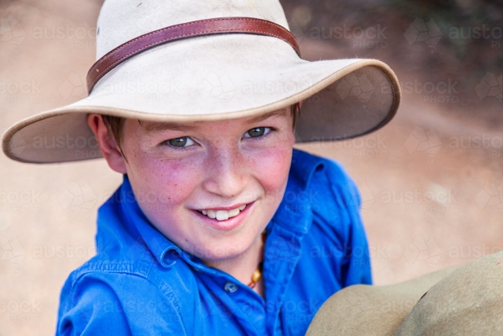 Happy young boy with freckles wearing hat - Australian Stock Image