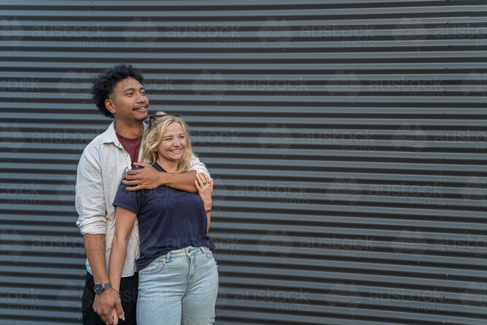 happy young couple smiling and hugging - Australian Stock Image