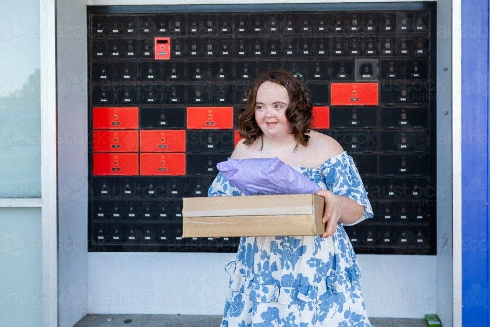 Image of Happy young lady holding parcels with compostable packaging ...