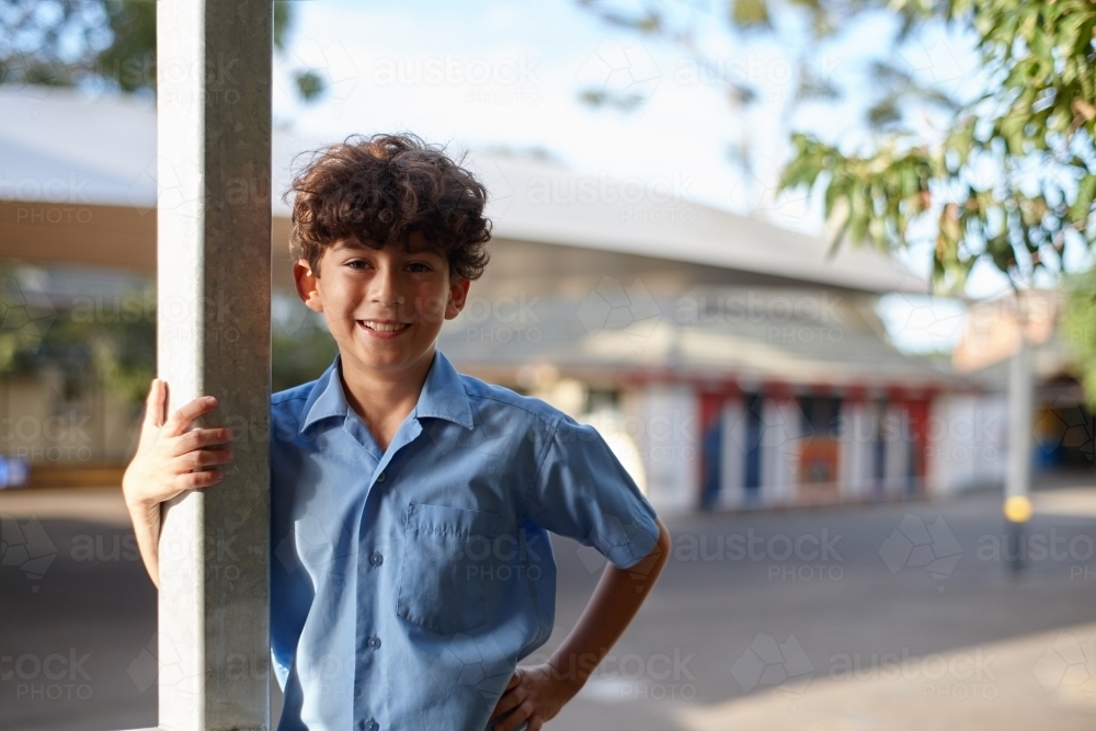 Happy young school boy at school grounds - Australian Stock Image