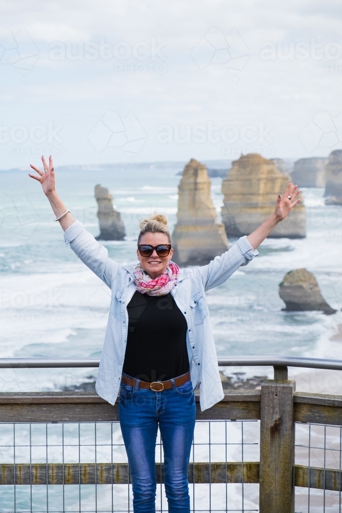 Happy young woman at the twelve apostles - Australian Stock Image