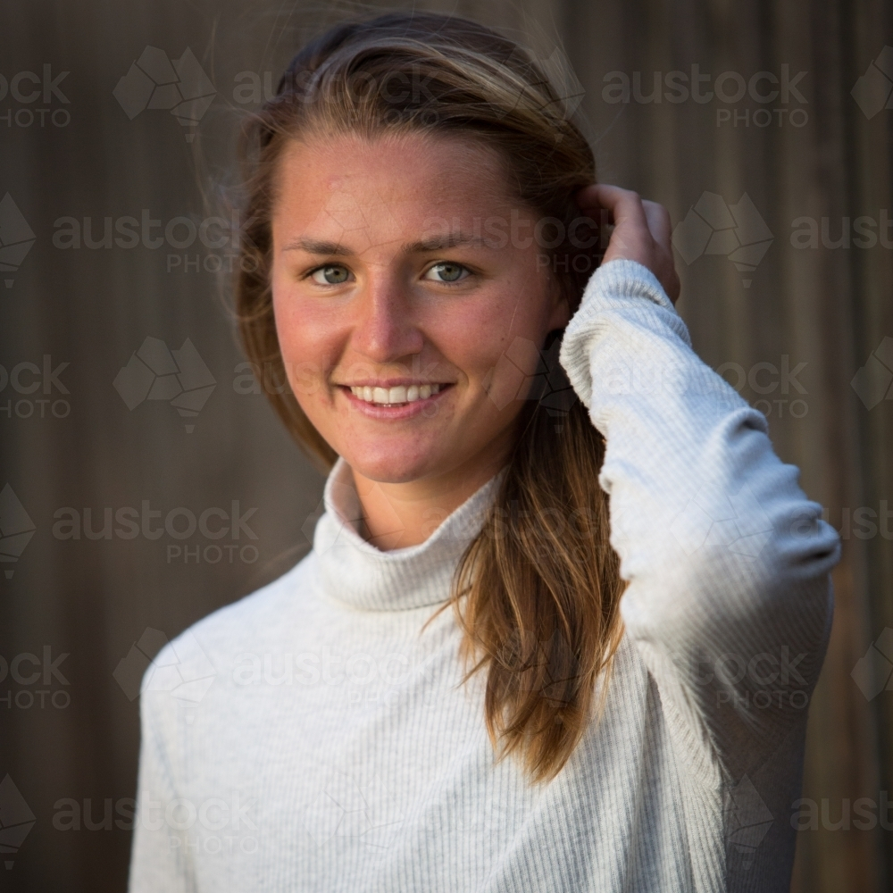 Happy Young Woman holding her hair back - Australian Stock Image