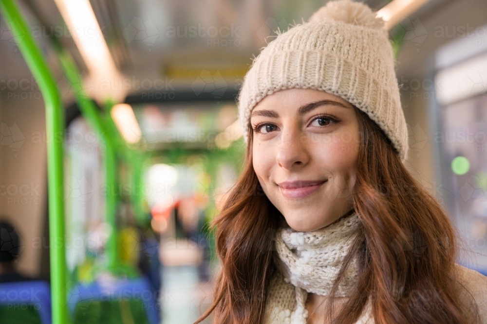 Happy Young Woman On the Tram in Winter - Australian Stock Image