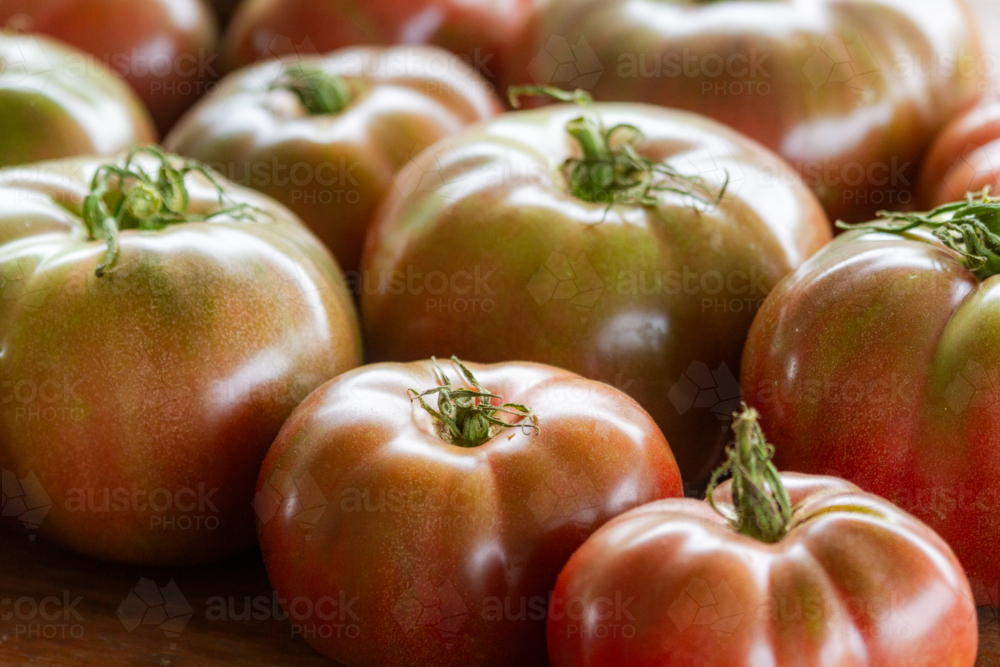 Harvested Cherokee Purple tomatoes side by side. - Australian Stock Image