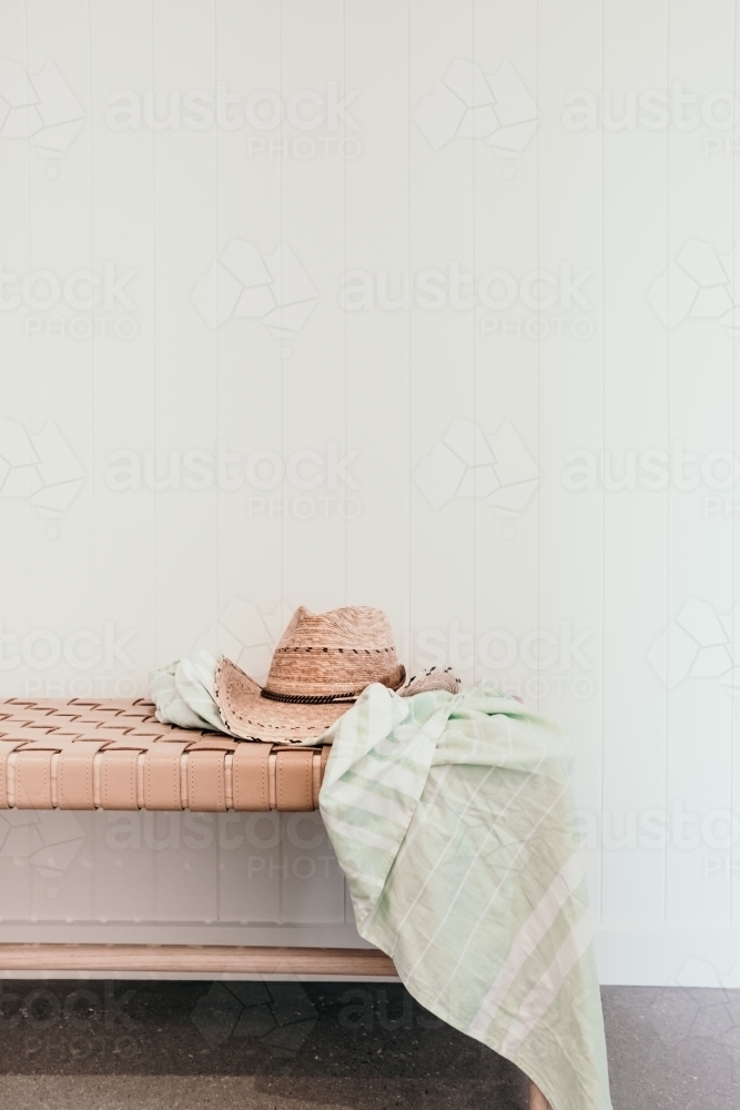 Hat and towel on a bench seat. - Australian Stock Image