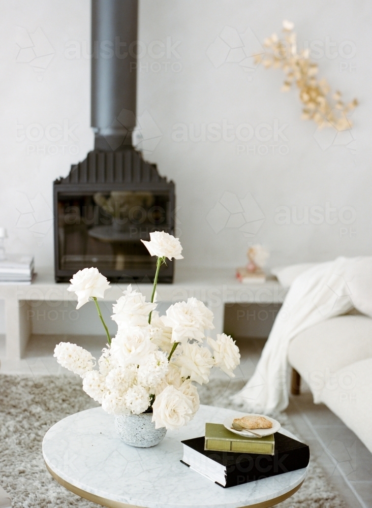 Having Afternoon Tea in Pretty Living Room with White Furnitures and Fire Place and White Roses - Australian Stock Image