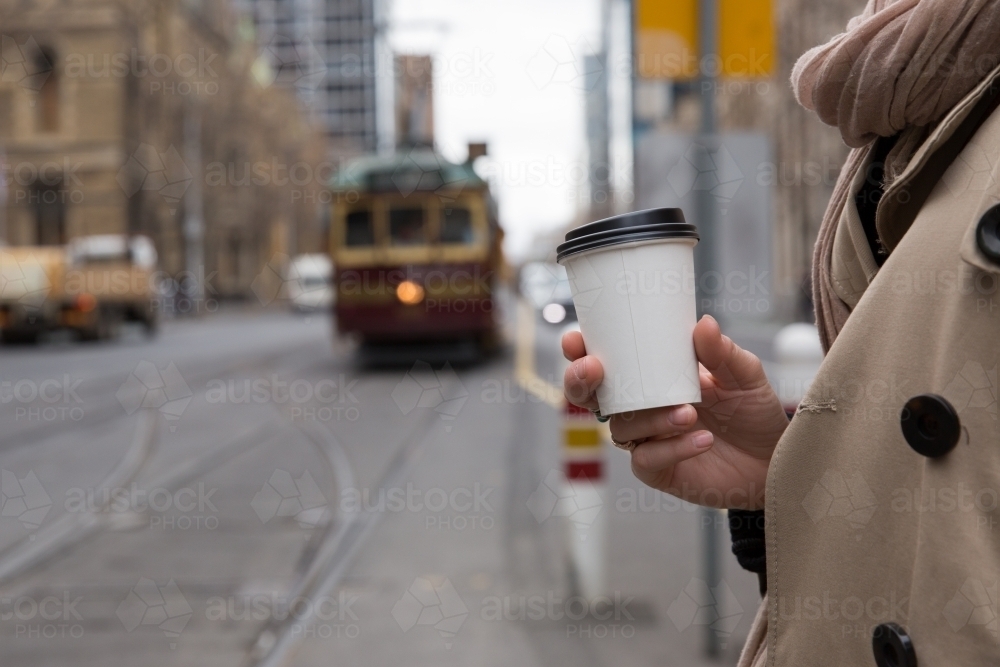 Having Take Away Coffee Waiting for the Tram - Australian Stock Image