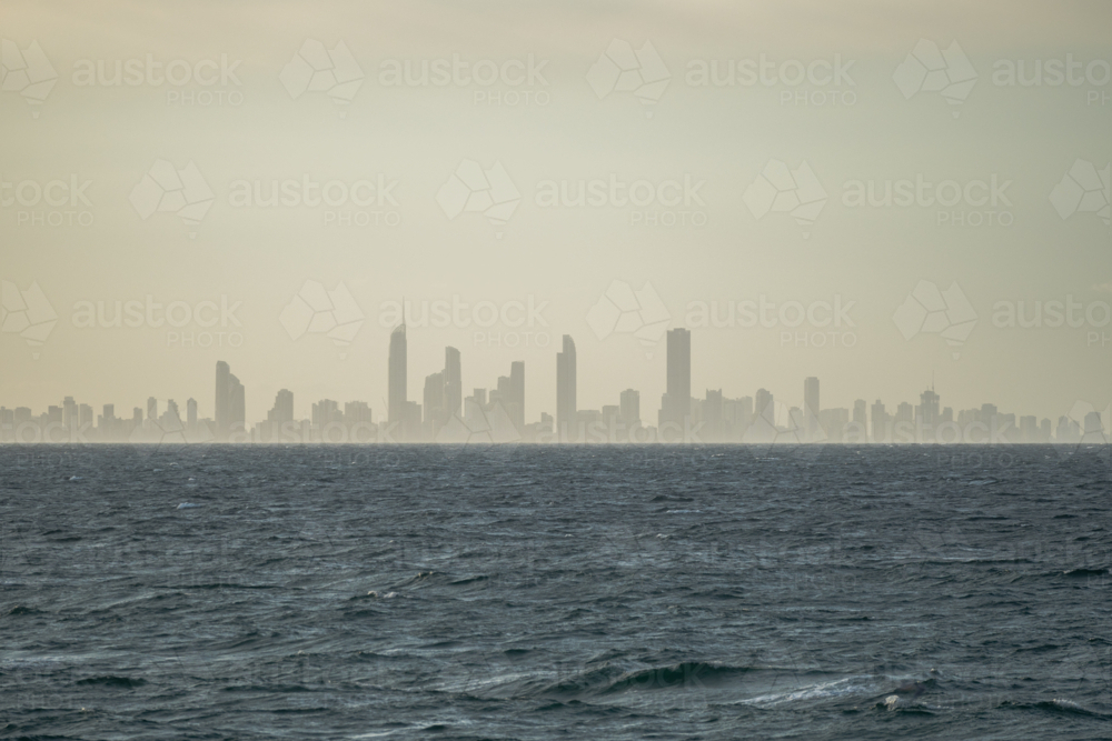 Hazy cityscape in a distant under overcast sky - Australian Stock Image