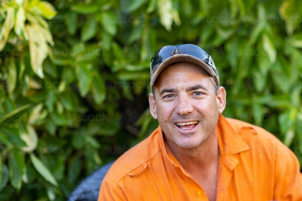 head and shoulders of happy smiling man outdoors - Australian Stock Image