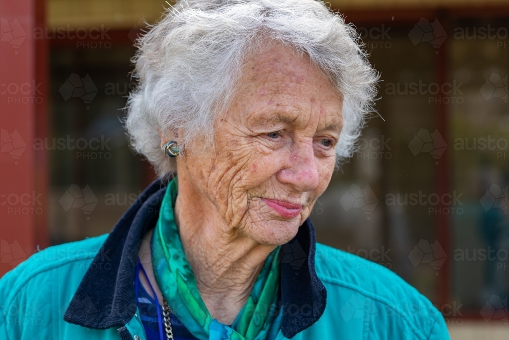 Image of head and shoulders of old lady with grey hair and wrinkled skin  looking away - Austockphoto