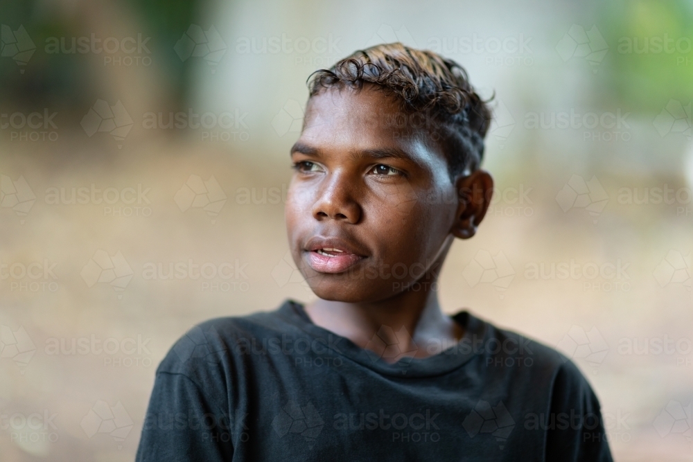 head and shoulders of one teenage boy with blurry background - Australian Stock Image