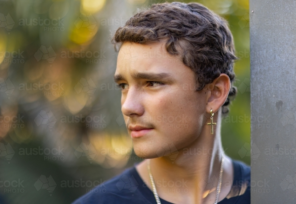 head and shoulders of teen boy looking away - Australian Stock Image