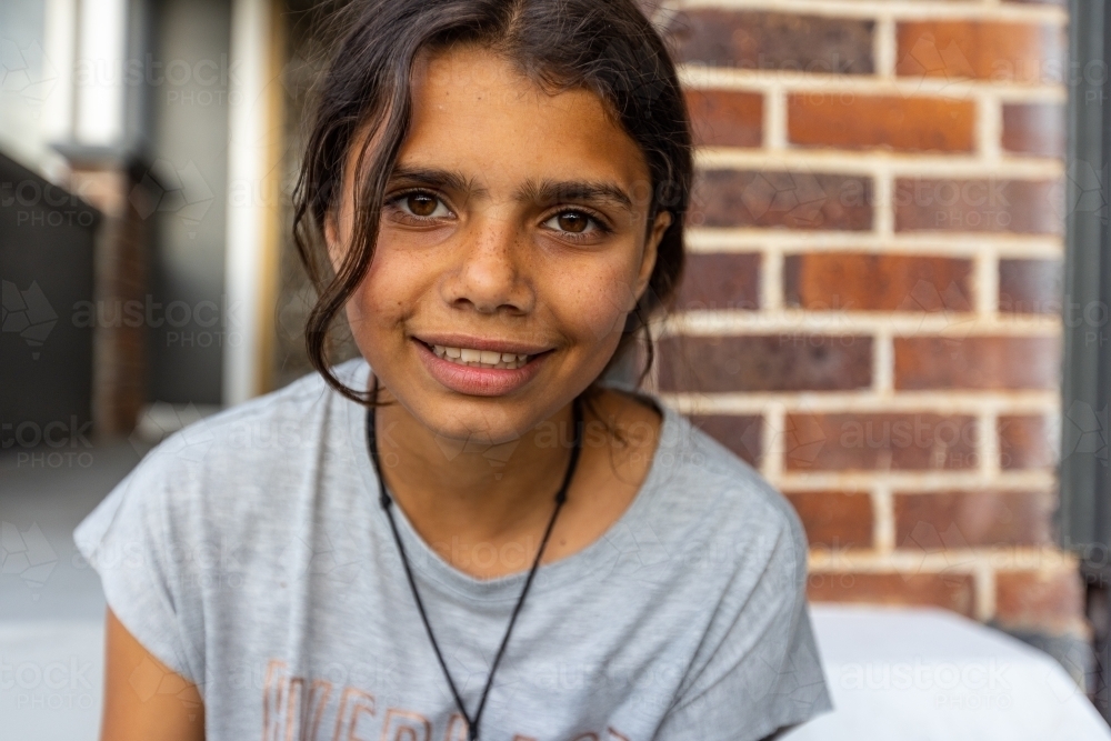 Image of head and shoulders of teen girl smiling and looking at camera ...