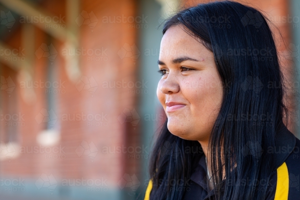 head and shoulders of teenage girl looking across frame - Australian Stock Image