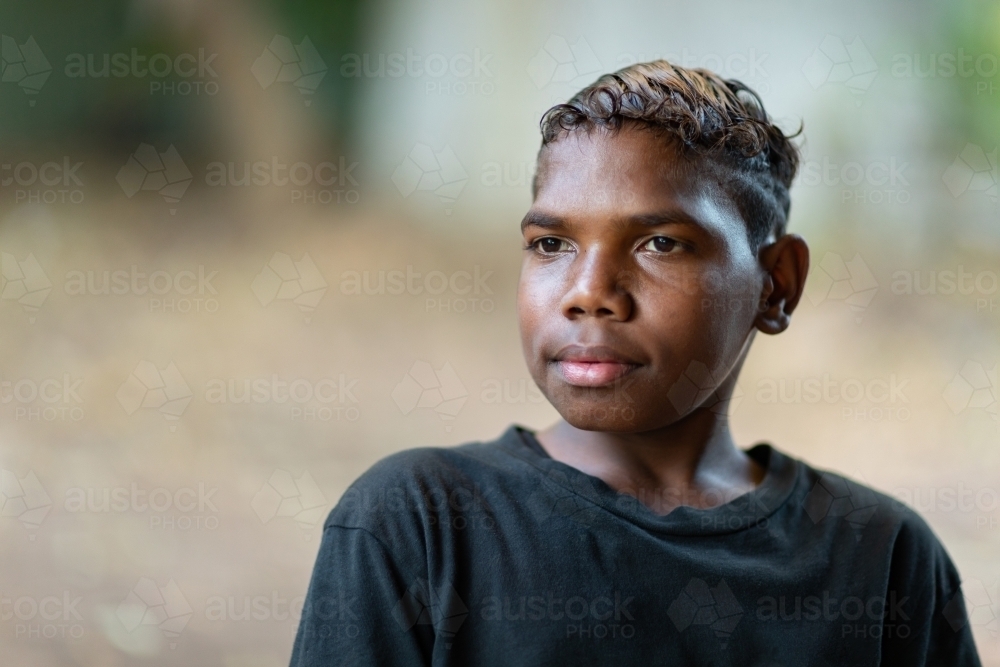 head and shoulders of teenager dressed in black with blurry background - Australian Stock Image