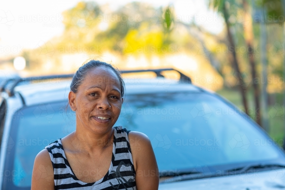 head and shoulders of woman by herself in front of car - Australian Stock Image