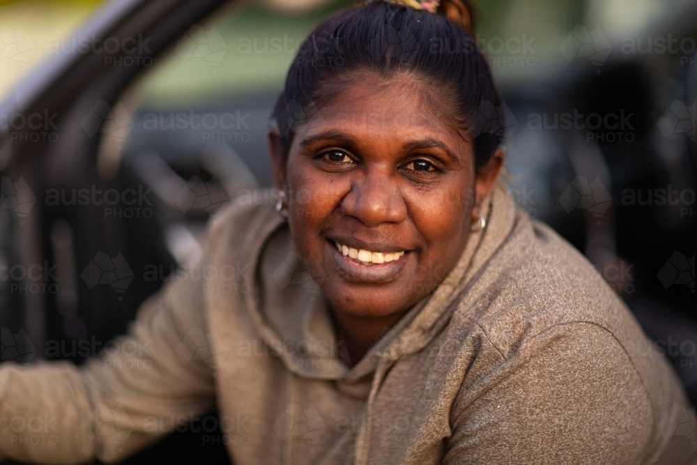 head and shoulders of woman getting out of a vehicle - Australian Stock Image