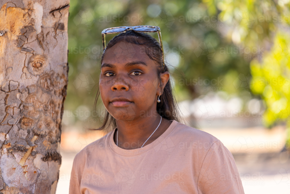 head and shoulders of young aboriginal woman with sunglasses on head in the Kimberley - Australian Stock Image