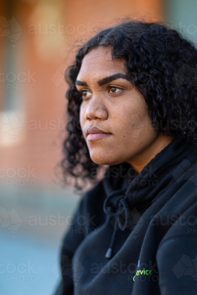 head and shoulders of young lady wearing black hoody - Australian Stock Image