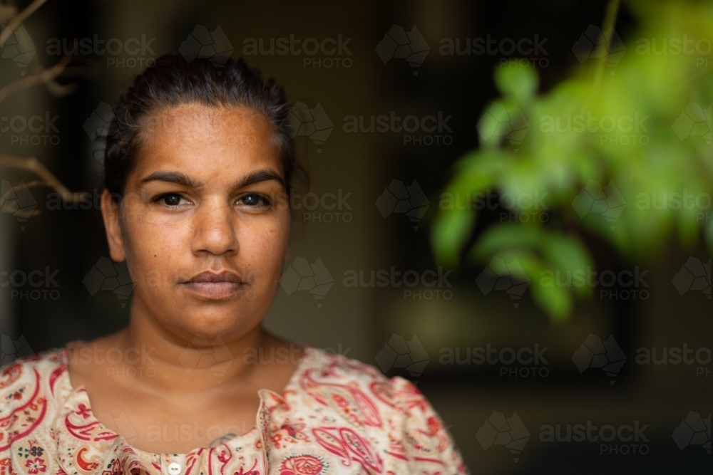 head and  shoulders of young woman looking out from veranda - Australian Stock Image