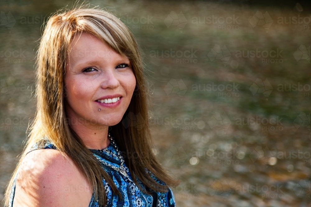 Head and shoulders portrait of a woman outdoors - Australian Stock Image