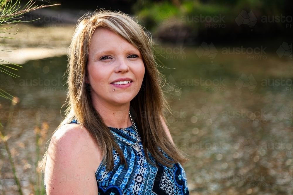Head and shoulders portrait of a woman outdoors - Australian Stock Image