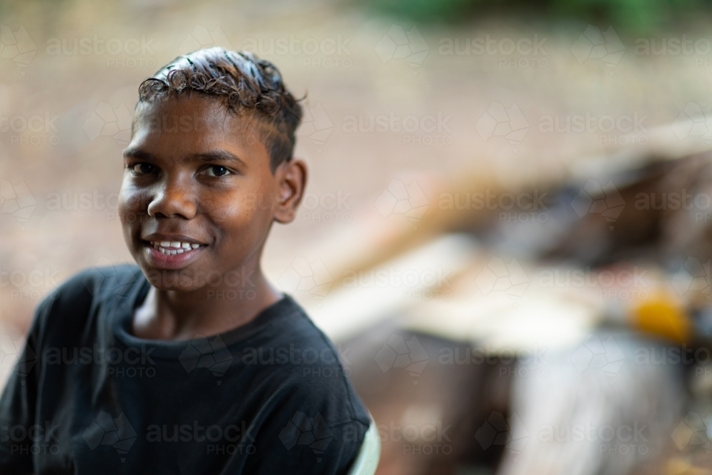 head and shoulders view of smiling teen boy in black t-shirt - Australian Stock Image