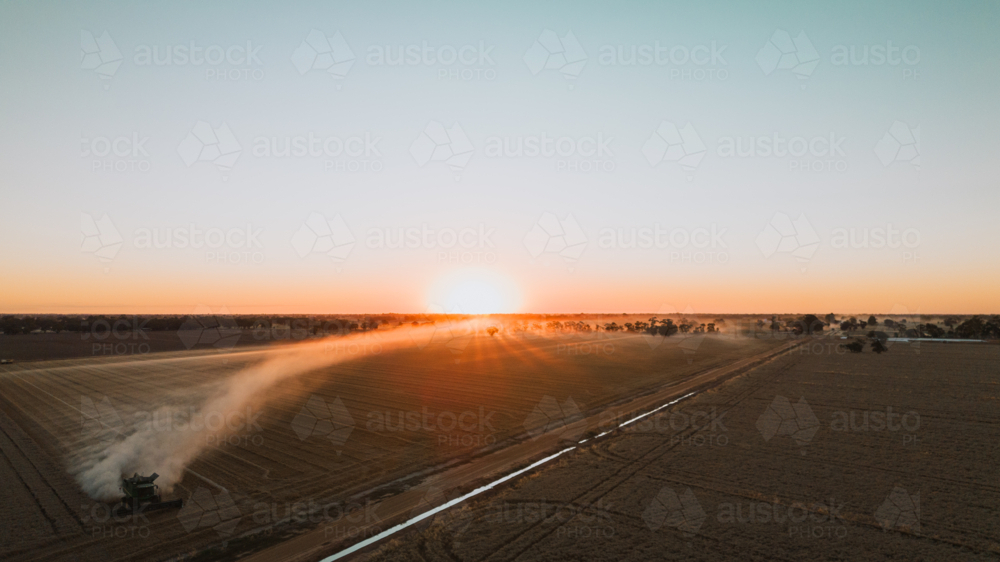 Header during harvest at sunset aerial view - Australian Stock Image
