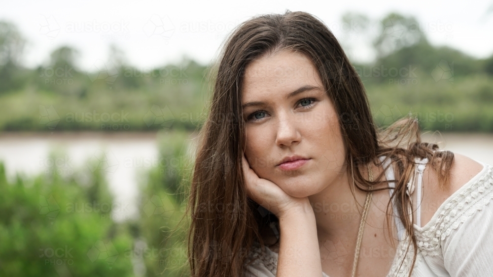 Headshot of pretty girl by the river - Australian Stock Image